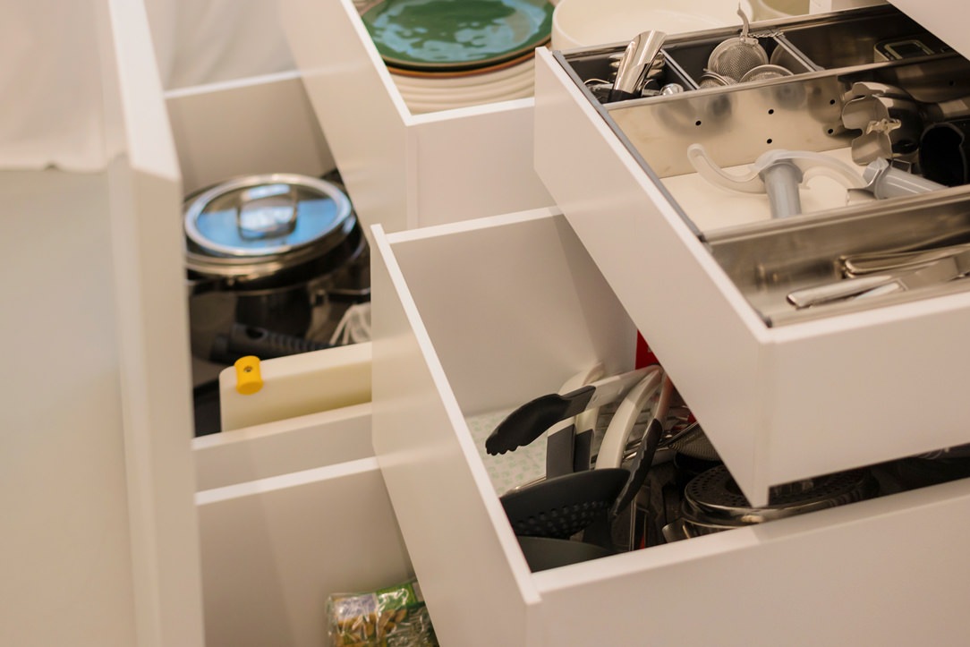 detail of internal drawers in white lacquered kitchen with island